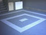 Garage floor with self-draining deck tiles